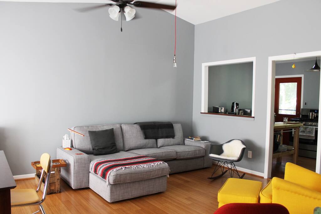 Modern and spacious living room where you are welcome to curl up with a book to read!