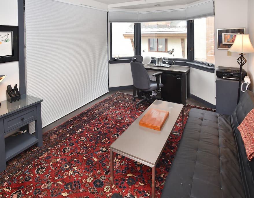 View of hotel room with bed stored