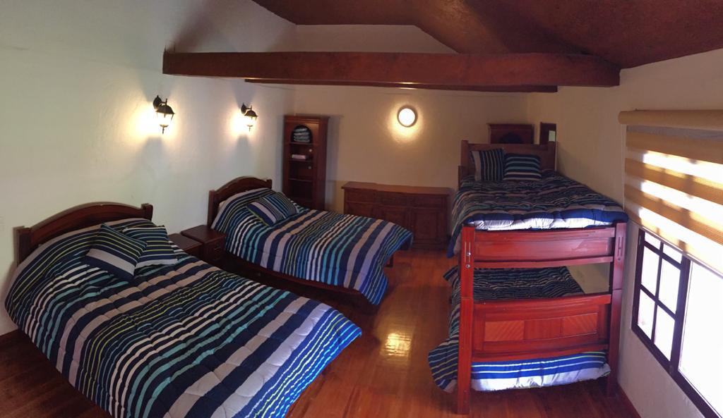 Bedroom 2 with 2 Queen beds and bunk bed, fireplace and bathroom
