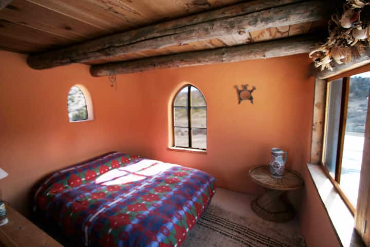 Loft bedroom with windows on four walls