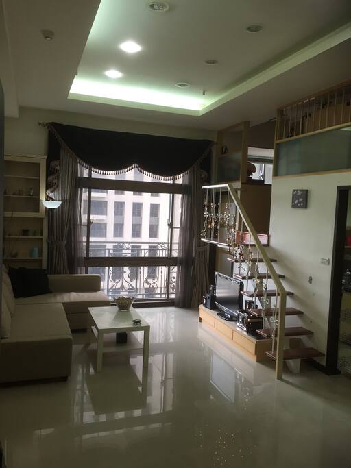 Spacious living room with a park view