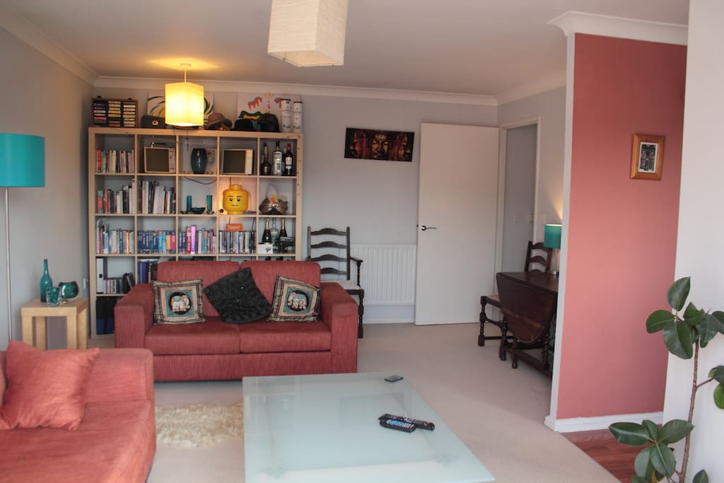Large living room. There is a fold out dining table in the corner.