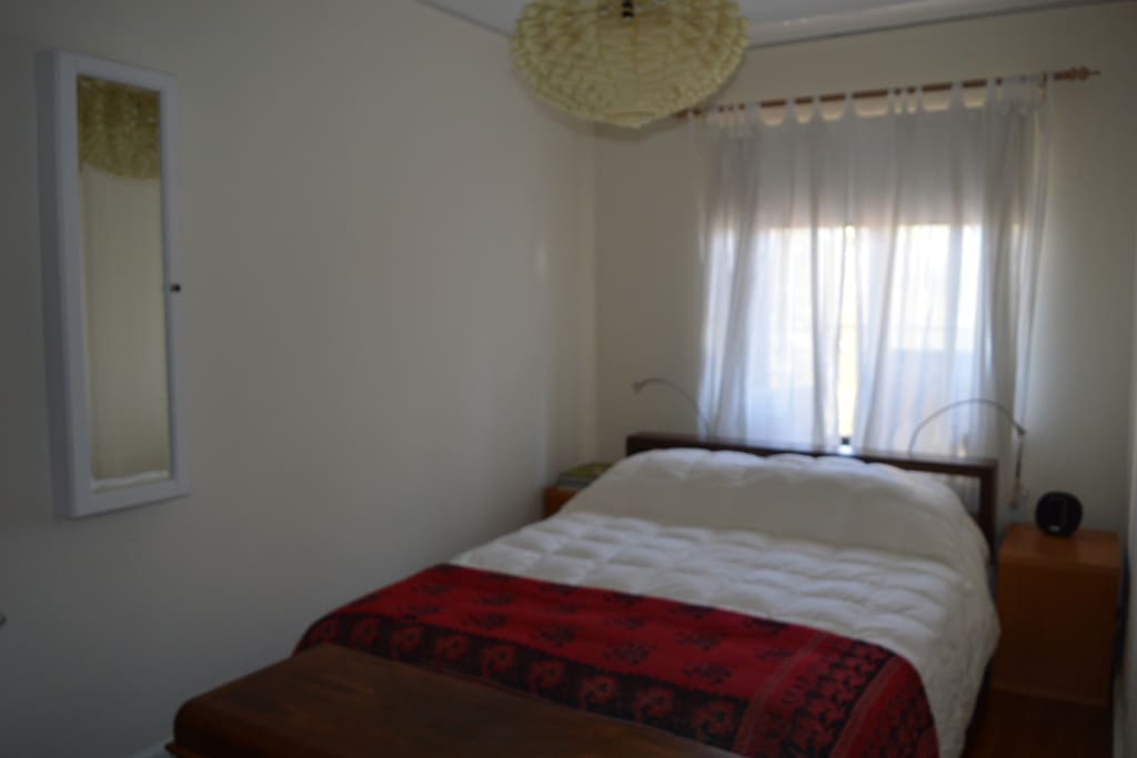 Bedroom with queen bed, frette sheets and duvet