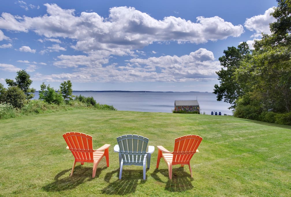 Sweeping lawn with panoramic water views & easy beach access