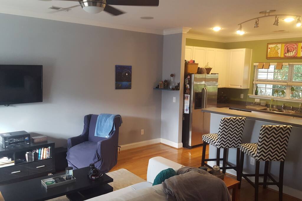 Living room and kitchen. Seating for dining @ the bar