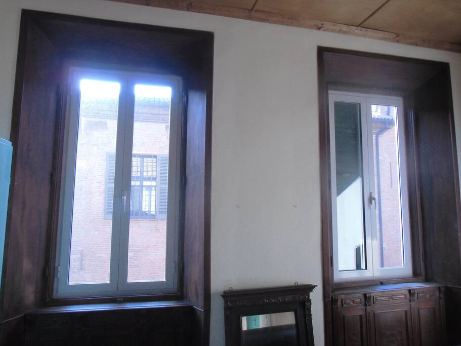 huge windows, facing 'Palazzo Paradiso' ('Paradise Palace', a Renaissance building)