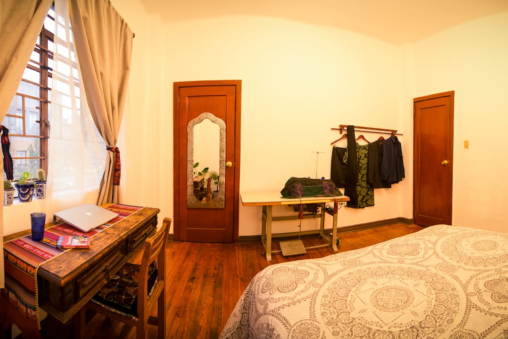 Left to right: your desk by the window, double curtains for a totally dark room at night, full length mirror, my sewing machine (extra desk space), a place to hang your clothes, the door to the rest of the apartment.