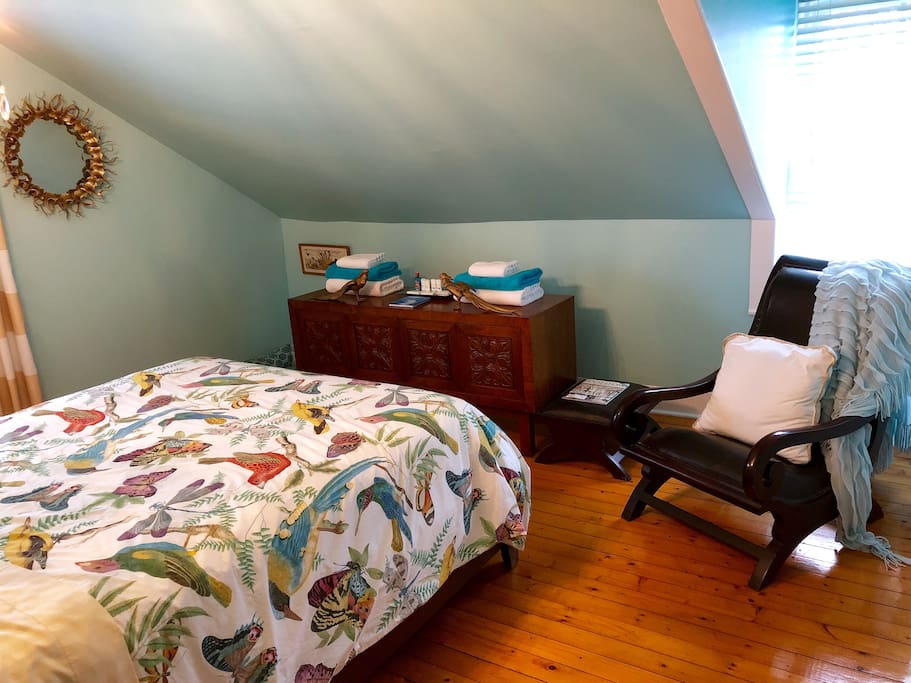 Turquoise Room has two bright windows and a comfortable plantation chair