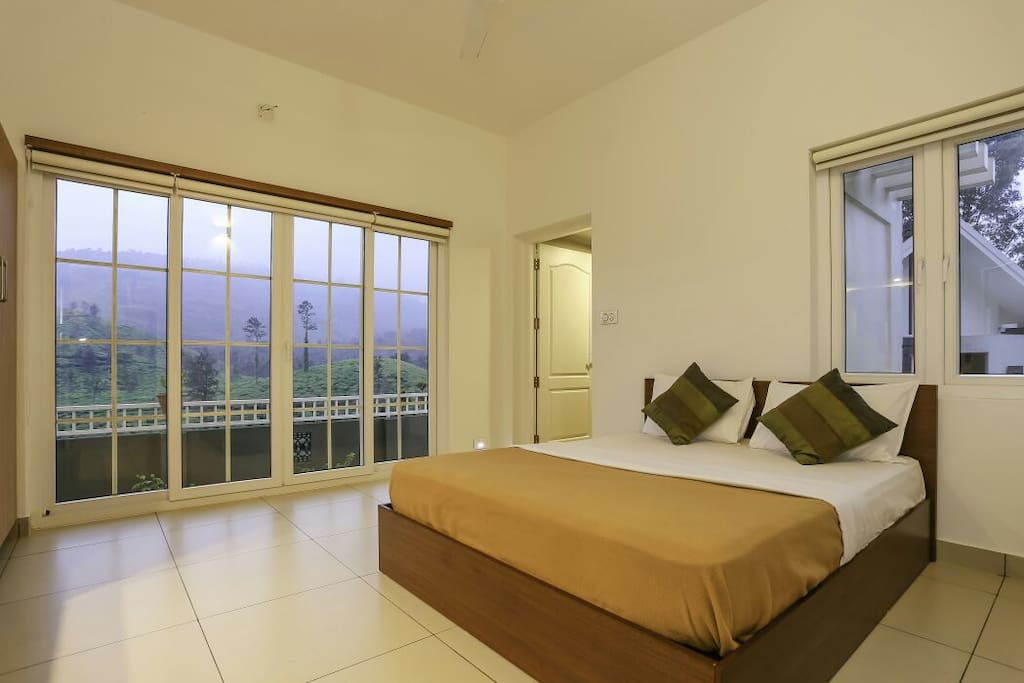 Bedroom with a spectacular view of the outdoors with a private balcony facing the Chembra peak!
