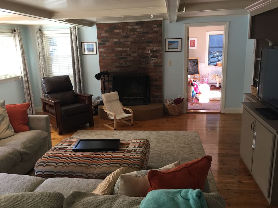Large living room with fireplace and walkout to the fenced in backyard