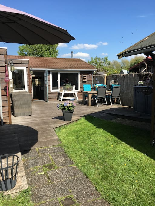 Rechter terras met eettafel en loungne bankje
