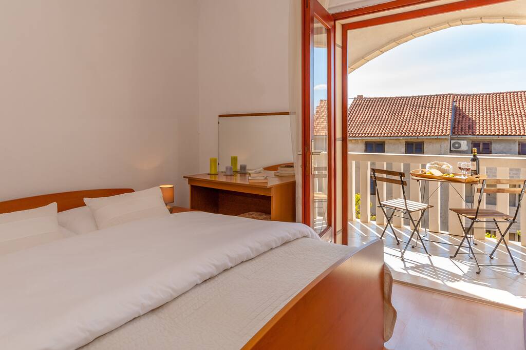 bedroom with double and single bed and balcony exit