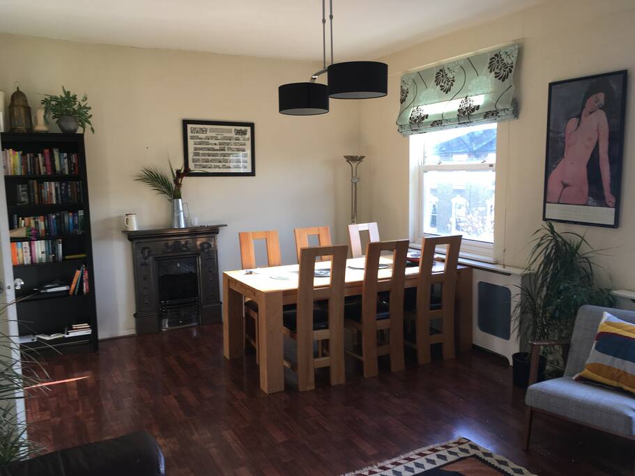Which has a large dining table by the window