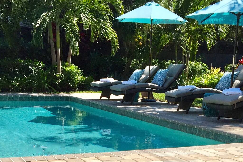 Comfortable loungers with cushions, beach towels and umbrellas.
