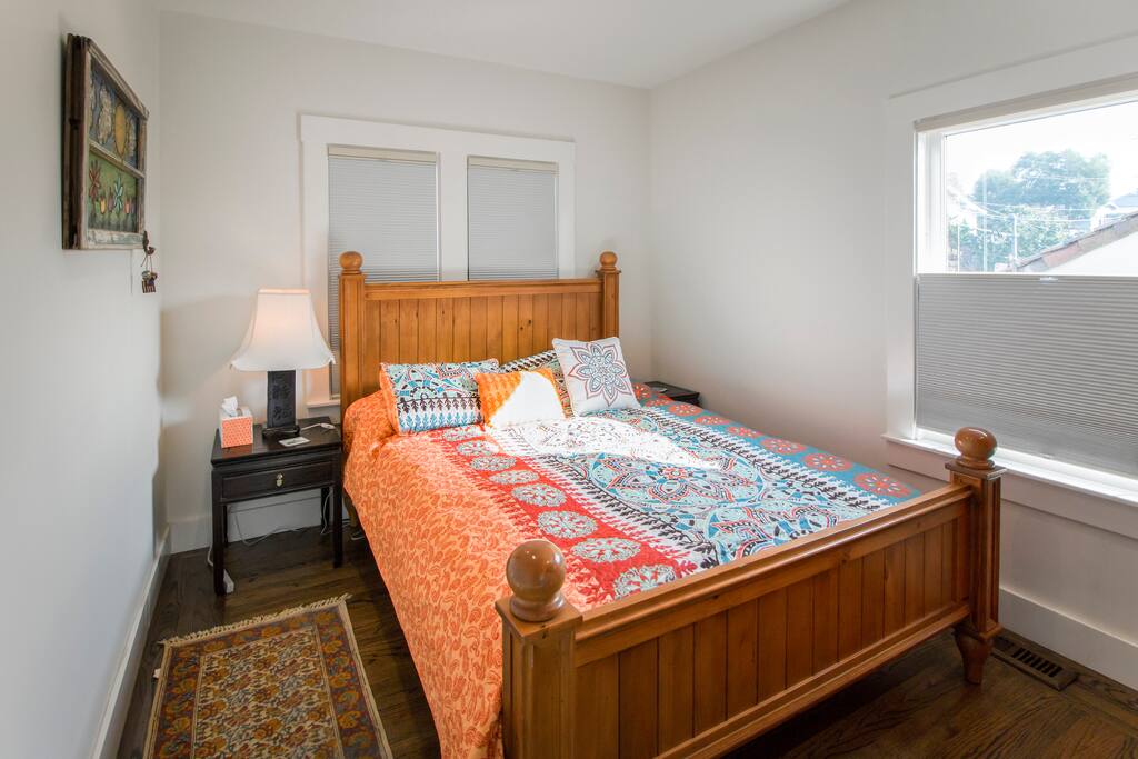 The skylight shines on the queen bed.
