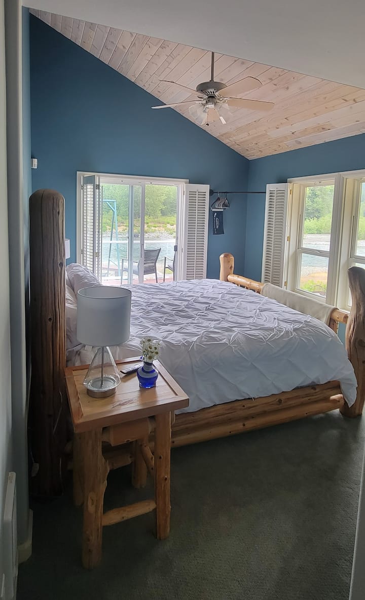 King sized bed in master. Lounge in custom cedar bed and listen to the river go by..