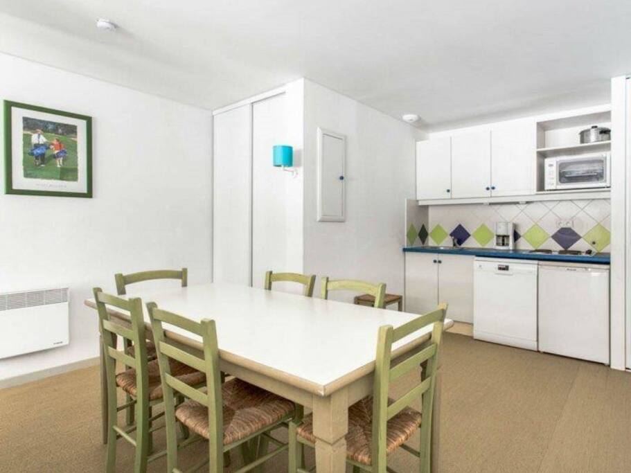 Nice living room with open plan kitchen and large wooden table for 6