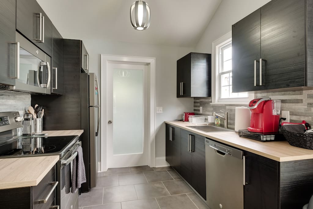 Stainless steel appliances with Ikea cabinets. Washer and dryer are in the utility room off the kitchen. Fridge is always stocked with soda and water.