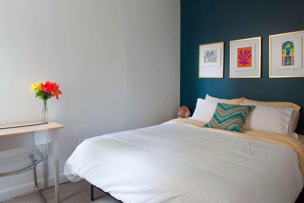 Queen size bed and bright workspace.