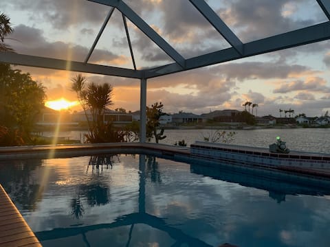 Waterfront villa w/ heated pool & lake view.
