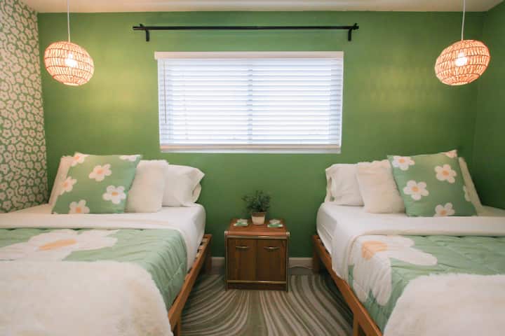 Good Vibes green room features two queen beds for maximum accommodation