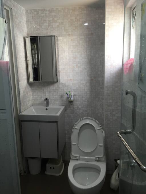 toilet inside master bedroom with heater & washer