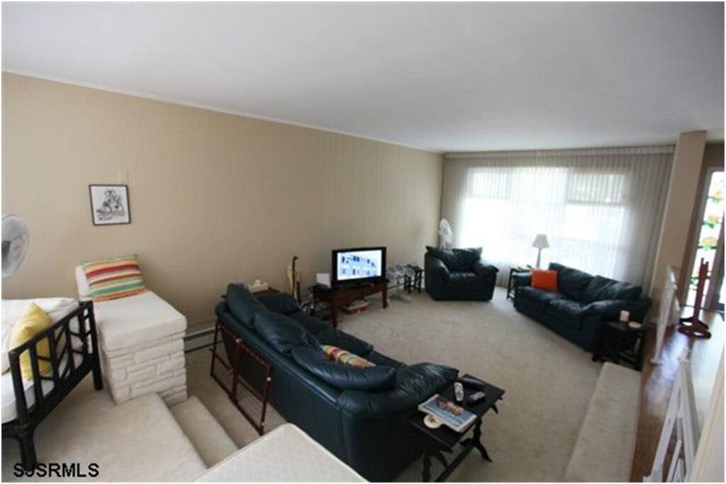 Living Room: Multi-level living room, lower level with TV.