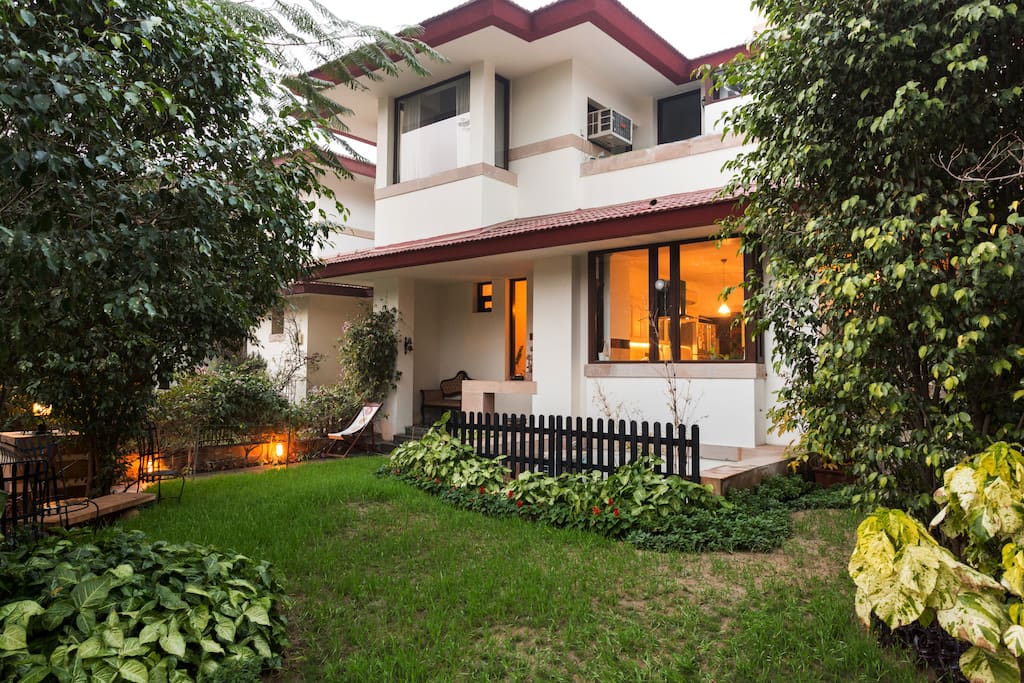 Lush green lawns surounded by dense foliage. Lots of birdsong and pretty birds to look at.