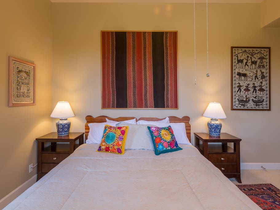Spacious King bedroom with high ceilings and ceiling fan.