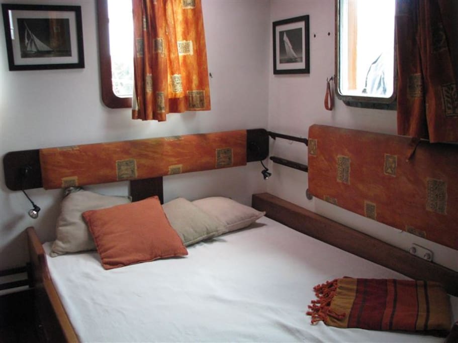 The main bedroom is at upper deck level, and has an en suite bathroom with a shower and toilet.