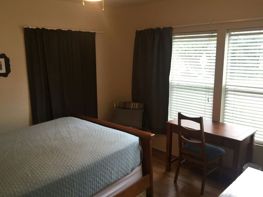 This bedroom also has additional seating, work desk and dresser.