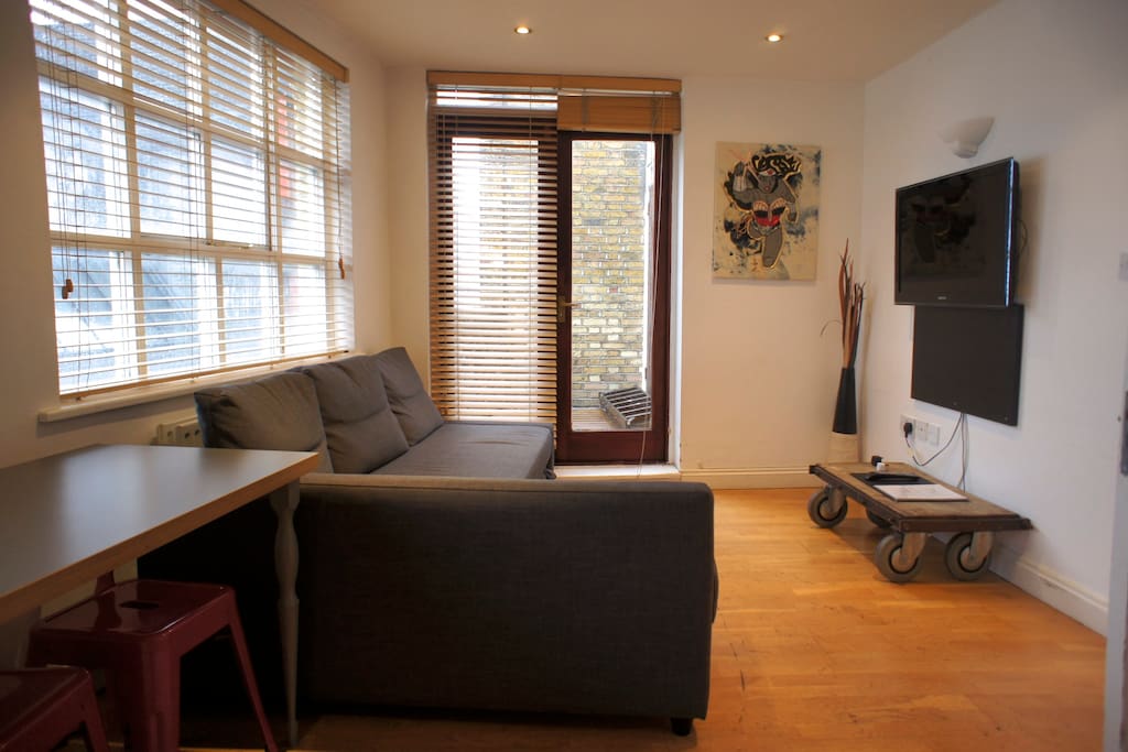 Here's the Living Room/Kitchen with Double Sofa Bed & Private Balcony