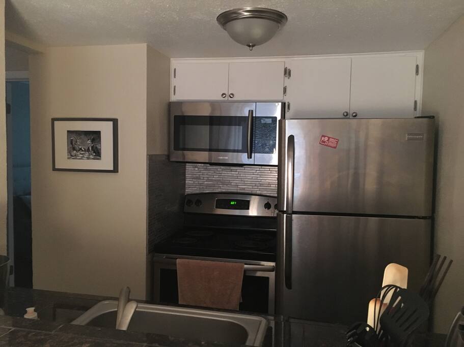 Small kitchen with all the baking utensils.
