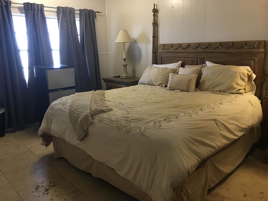King sized bed in private, lockable bedroom separated by kitchenette