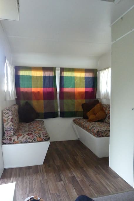 Couches in caravan make up to another double bed.
