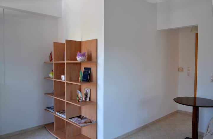 The living room offers a kitchen, dining table, sofa and coffee table. Kefalonia apartments