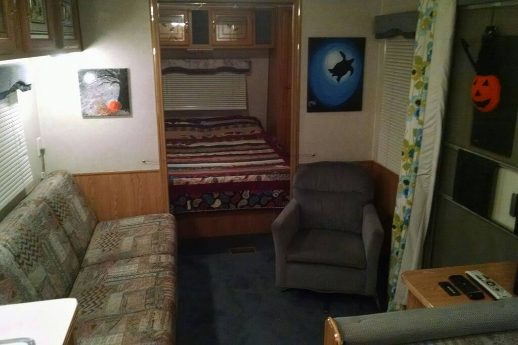 Living room with cable tv and couch that pulls out into a bed.