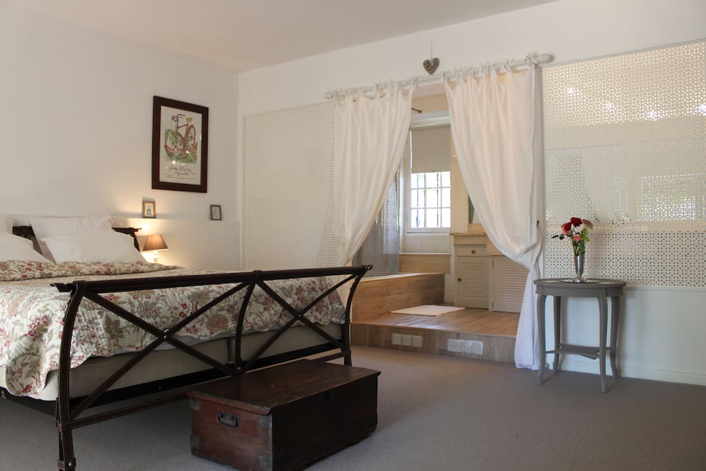 Refurbished ground floor superking bedroom with en-suite bathroom and wisteria clad terrace.