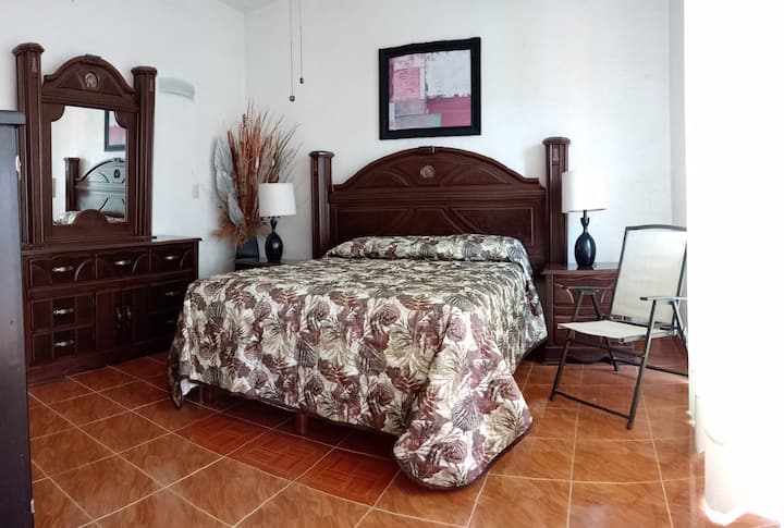 Large and comfortable queen size bed and with access to the terrace, also has its private bathroom and analogue tv with cable,  The windows have mosquito nets