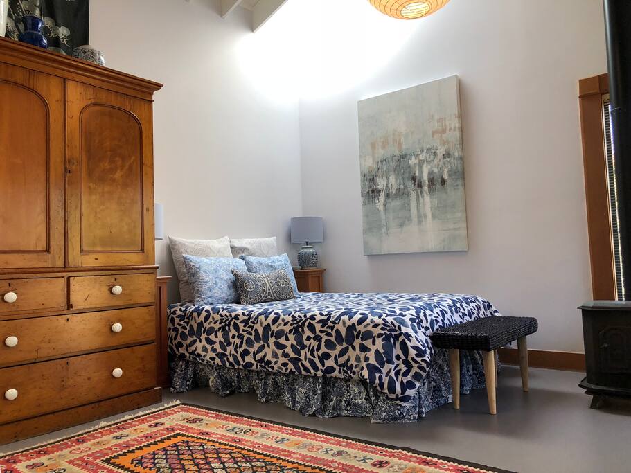 light filled space with cozy bed