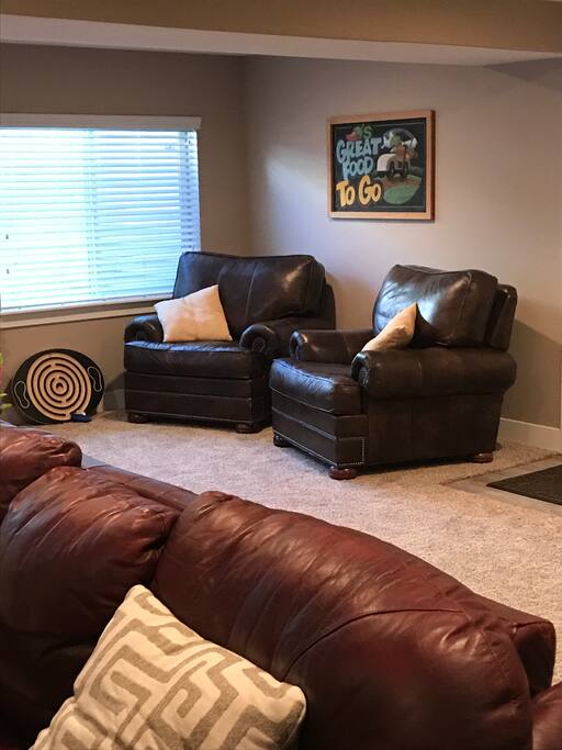Just inside the separate entrance to your downstairs suite, the spacious living room has 2 large leather chairs, couch and loveseat.
