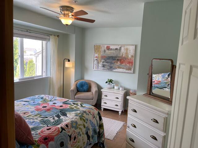The downstairs bedroom includes a queen bed with a down duvet, a comfy chair, and for storage, plenty of drawers and a closet for hanging clothes.