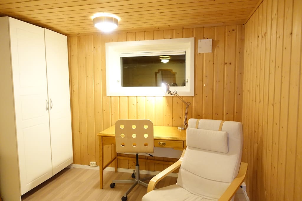 Bedroom from an other angle. Wardrobe, desk and armchair.