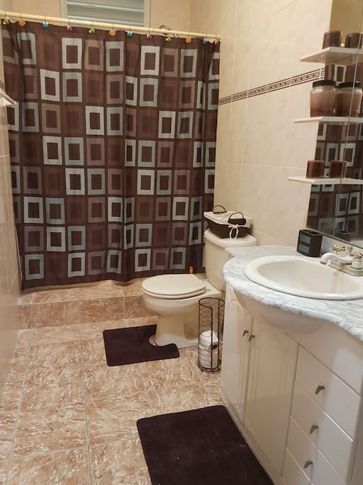 Spacious private bathroom with lock on door.