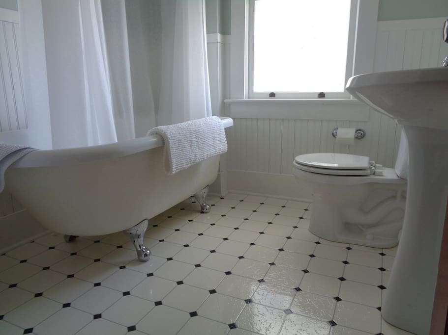 The Garden Room includes a private bathroom featuring a claw-foot tub