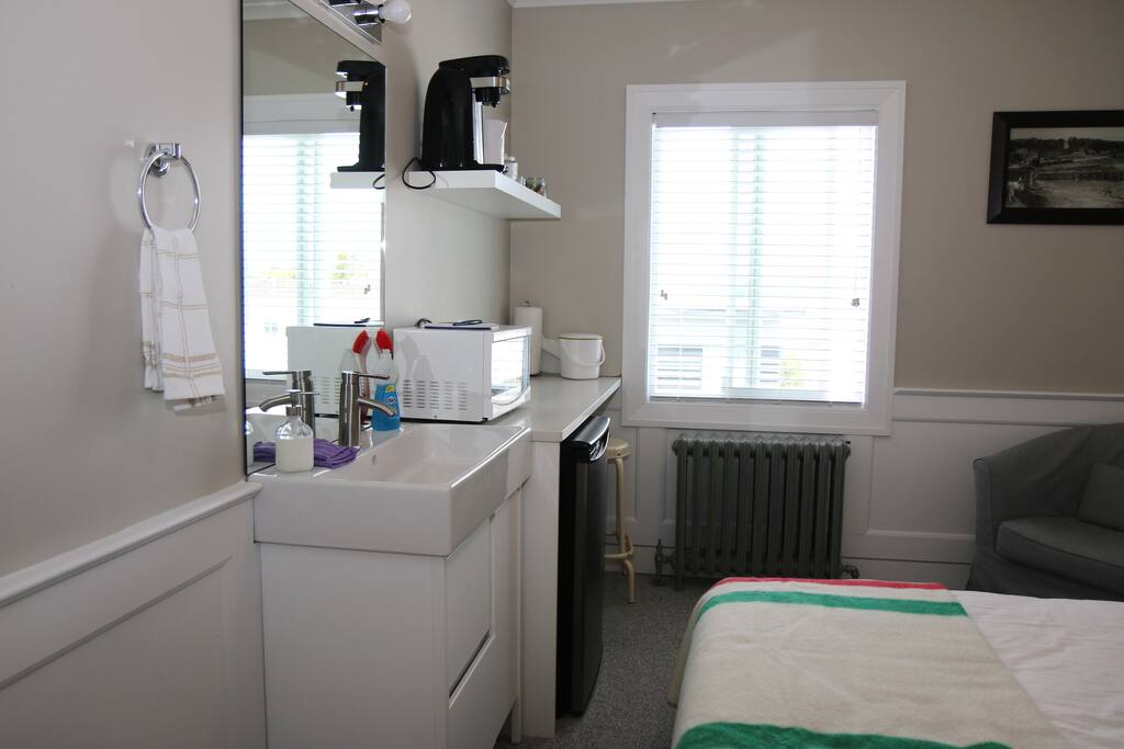 Your own sink and kitchenette with bar fridge, microwave and more