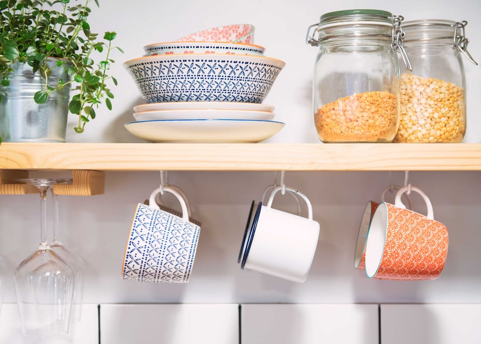 Lots of open shelving with plenty of crockery and kitchenware