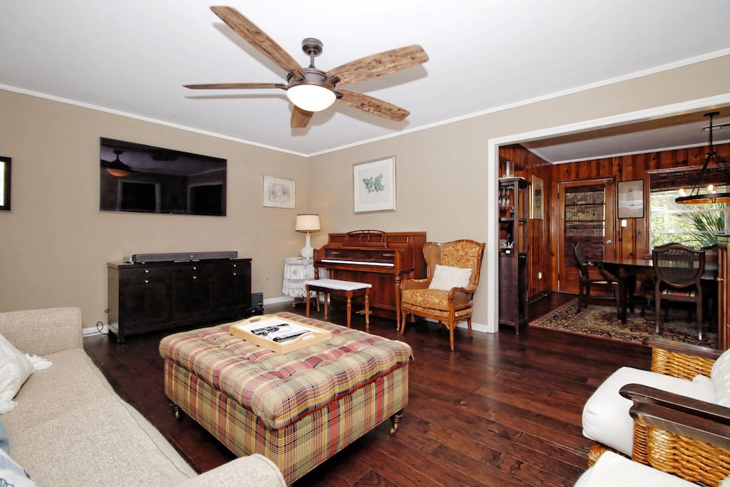 Open living room with ample light and a large TV with over 200 DirecTv channels.