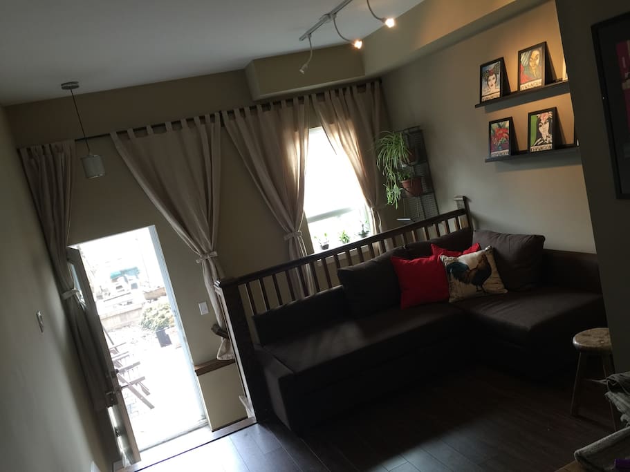 Living room with brand new sofa bed that sleeps two comfortably. The back door leads to a full yard with a patio and two parking spots