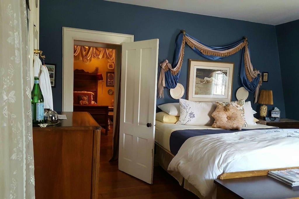 A door way separates the king bed from the twin and the private bath